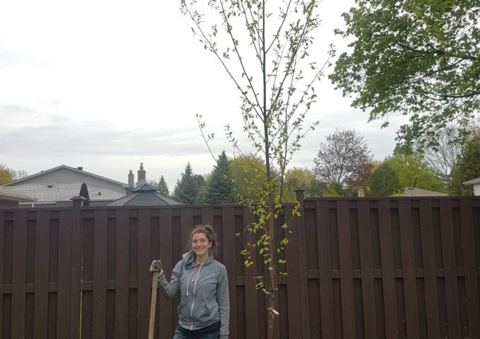 Woman in backyard with tree